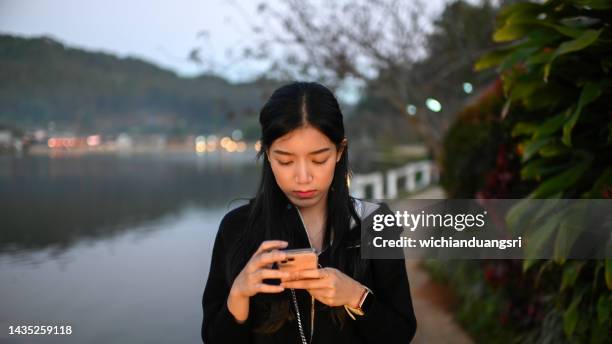 a young female tourist uses a mobile phone to see the nature. - mae hong son province bildbanksfoton och bilder