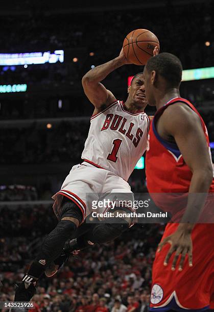 Derrick Rose of the Chicago Bulls grimaces as he goes up to pass over Lavoy Allen of the Philadelphia 76ers after apparently injuring his knee in...