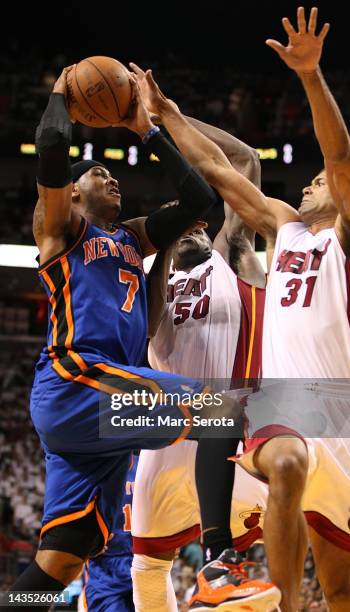 Forward Carmelo Anthony of the New York Knicks is defended by Forward Joel Anthony and Shanes Battier of the Miami Heat in Game One of the Eastern...