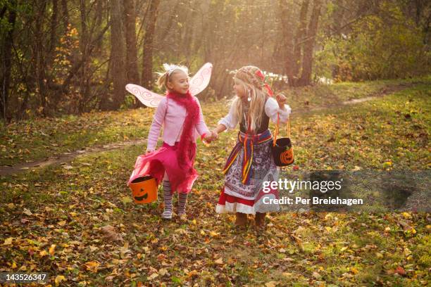 halloween girls holding hands - wingwalking stock pictures, royalty-free photos & images