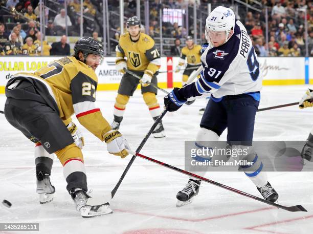 Cole Perfetti of the Winnipeg Jets shoots against Shea Theodore of the Vegas Golden Knights in the third period of their game at T-Mobile Arena on...