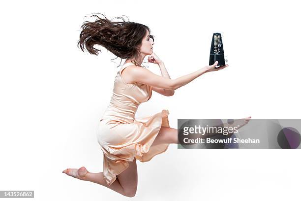 woman dancer in pearls and dress with metronome - metronomo foto e immagini stock