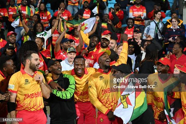Members of Team Zimbabwe celebrate victory in the ICC Men's T20 World Cup match between Scotland and Zimbabwe at Bellerive Oval on October 21, 2022...