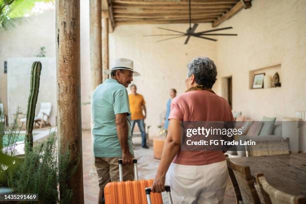 senior man talking to his wife upon arriving at the lodging - hitting enter stock pictures, royalty-free photos & images