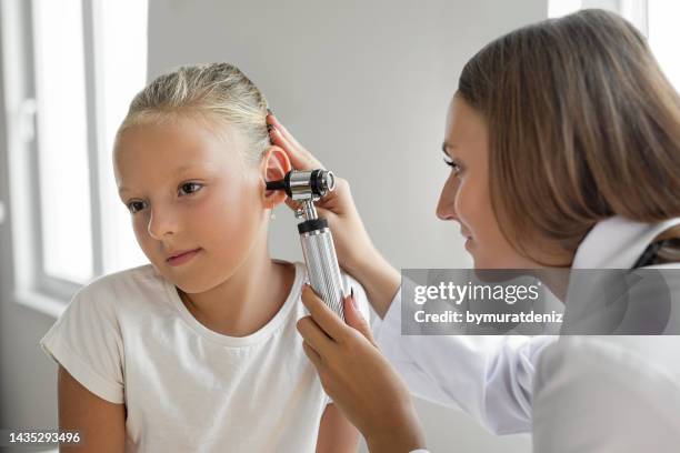 girl patient is getting an ear examination - human ear bildbanksfoton och bilder