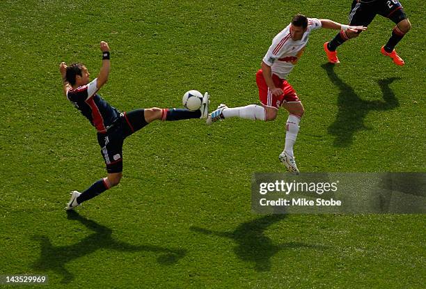 Kenny Cooper of the New York Red Bulls and Greg Jordan of the New England Revolution battle for control of the ball at Red Bull Arena on April 28,...