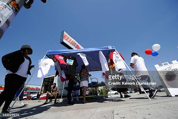 Residents sell shirts commemorating the Los Angeles riots at the intersection of Florence and Normandie Avenues on April 28, 2012 in Los Angeles,...