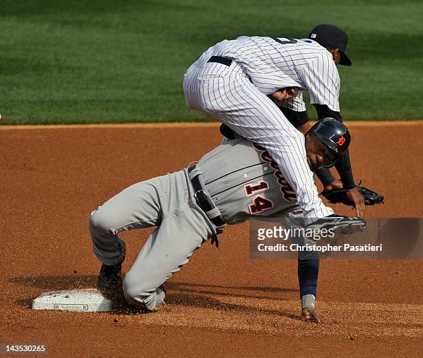 Austin Jackson of the Detroit Tigers collides with Eduardo Nunez of the New York Yankees as he steals second base in the top of the first inning...