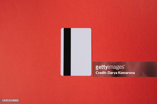 the white plastic card on isolated red background. mockup for your design. design element with copy space. - credit card mockup stock pictures, royalty-free photos & images