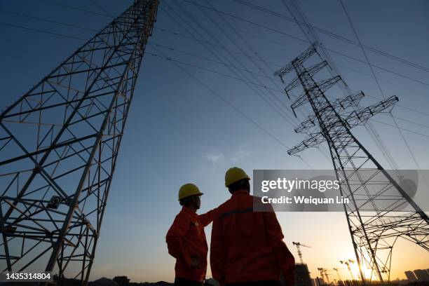 workers are checking high-voltage power lines. - electricity pylon stock pictures, royalty-free photos & images