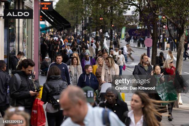Shoppers walk down Oxford Street on October 21, 2022 in London, England. The Office For National Statistics announced that September's retail sales...