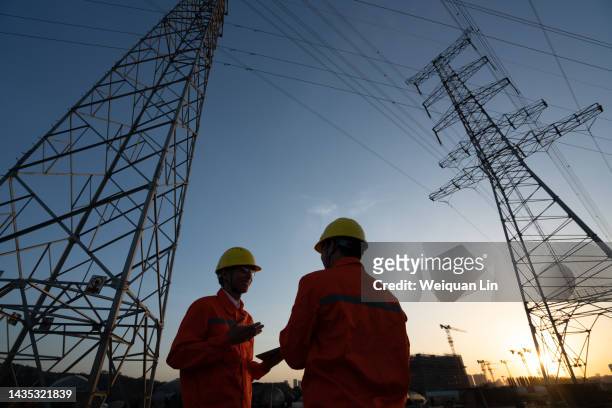 workers are checking high-voltage power lines. - suministro de energía fotografías e imágenes de stock