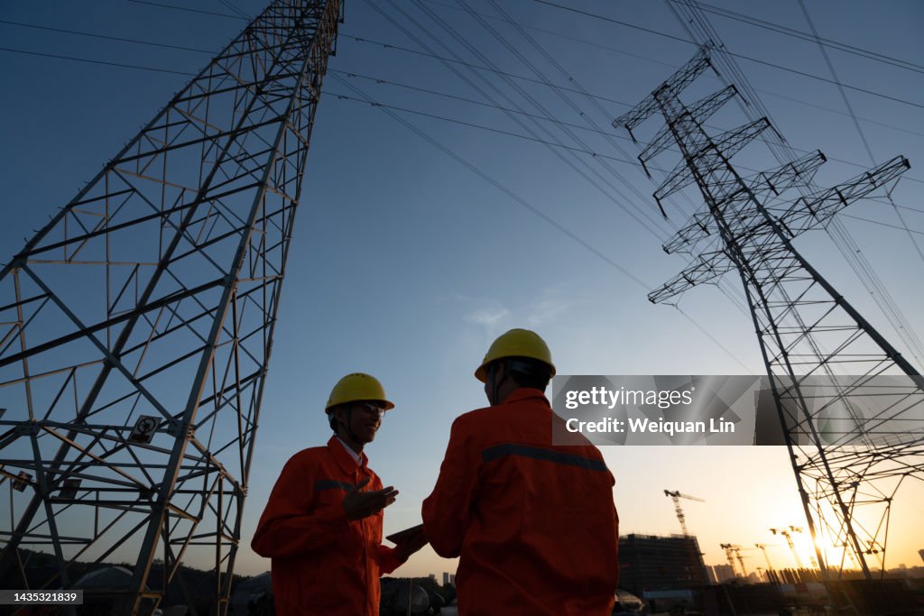 Workers are checking high-voltage power lines.