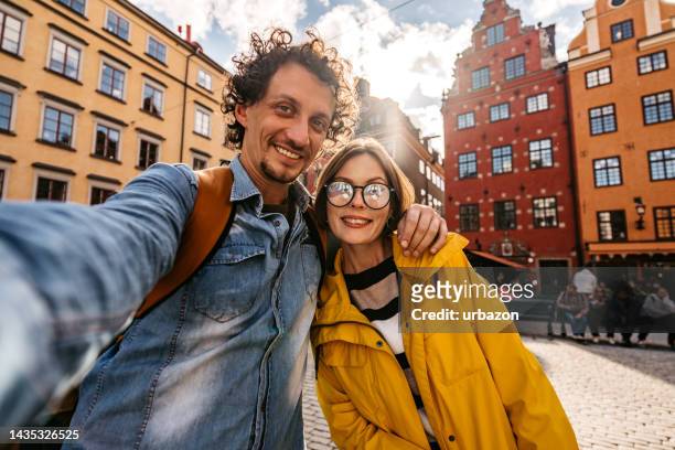 young couple taking a selfie in stockholm - self portrait photography stock pictures, royalty-free photos & images
