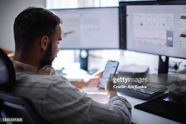 computer programmer testing a new software program. - multiple screens stockfoto's en -beelden