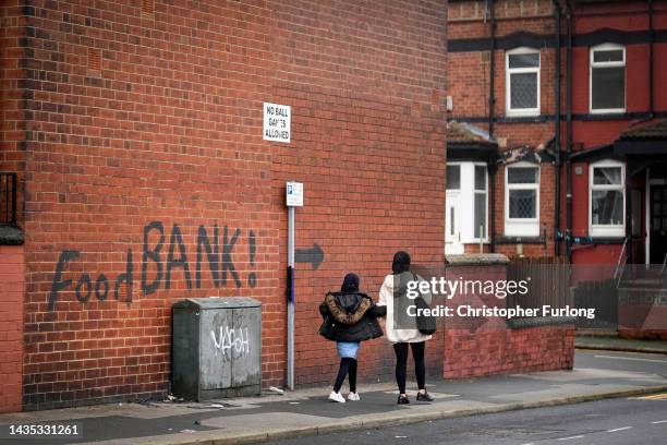 Sign painted on the side of a house directs people to a local food bank on October 21, 2022 in Leeds, England. A report from the Office for National...