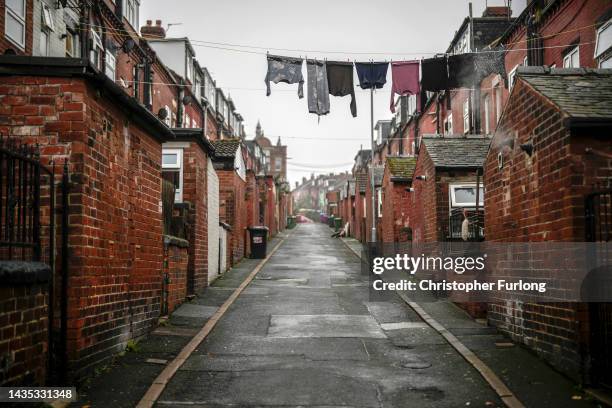 Washing hangs from a line at the back of houses on October 21, 2022 in Leeds, England. A report from the Office for National Statistics published...