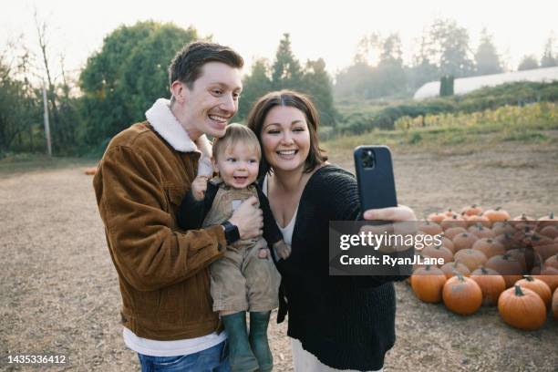 family picking pumpkins at local farm - calling festival stock pictures, royalty-free photos & images