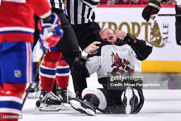 Zack Kassian of the Arizona Coyotes sits on the ice after fighting Arber Xhekaj of the Montreal Canadiens during the first period at Centre Bell on...