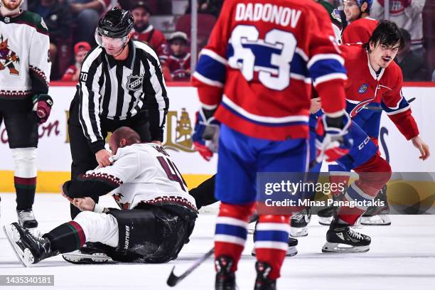 Zack Kassian of the Arizona Coyotes tries to get up on his feet as Arber Xhekaj of the Montreal Canadiens skates off after fighting during the first...