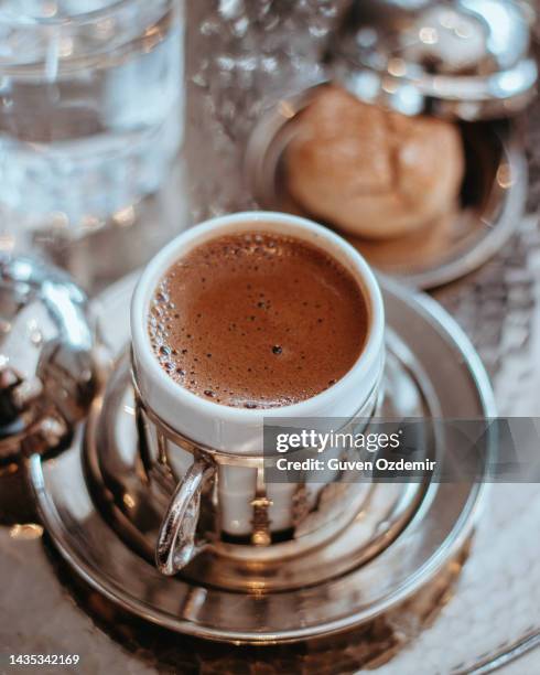 traditional turkish coffee cup and cookies service, traditional embossed metal tray and cup with turkish coffee and cookies, traditional coffee concept - cezve stockfoto's en -beelden