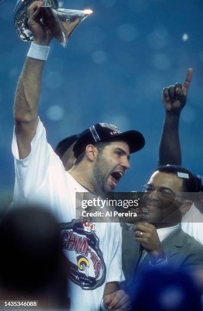 Quarterback Kurt Warner of the St. Louis Rams celebrates winning Super Bowl XXXIV in the post game celebration with the Vince Lombardi Trophy after...