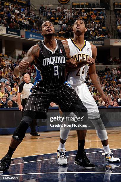 Earl Clark of the Orlando Magic looks to rebound against Paul George of the Indiana Pacers in Game One of the Eastern Conference Quarterfinals during...