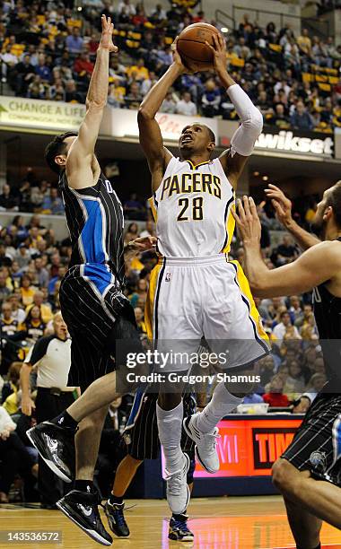 Leandro Barbosa of the Indiana Pacers tries to get a shot off past J.J. Redick of the Orlando Magic in Game One of the Eastern Conference...