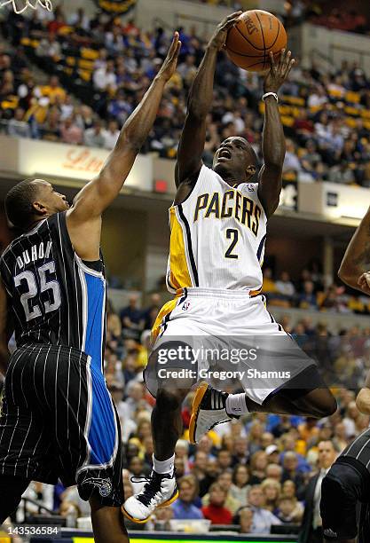 Darren Collison of the Indiana Pacers tries to get a shot off past Chris Duhon of the Orlando Magic in Game One of the Eastern Conference...