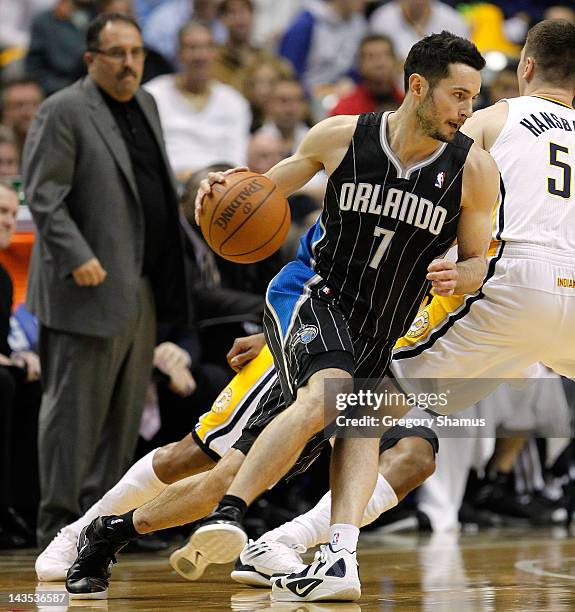 Redick of the Orlando Magic tries to get around Tyler Hansbrough of the Indiana Pacers with head coach Stan Van Gundy looking on in Game One of the...