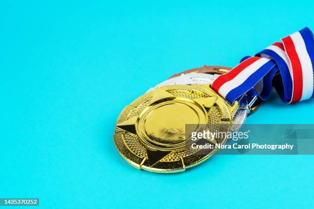 medals on blue background - silver medal with ribbon stock pictures, royalty-free photos & images