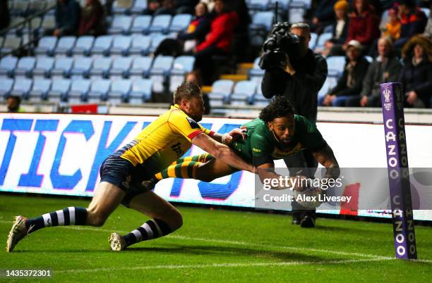 Josh Addo-Carr of Australia goes over to score their sides first try during the Rugby League World Cup 2021 Pool B match between Australia and...