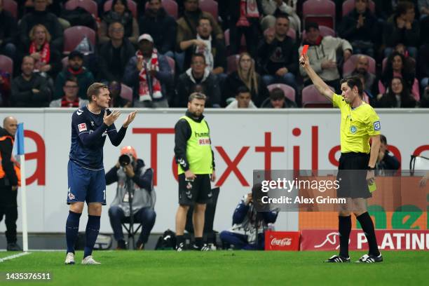 Luca Kilian of 1. FC Koeln is shown a red card by referee Matthias Jollenbeck during the Bundesliga match between 1. FSV Mainz 05 and 1. FC Köln at...