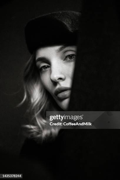 beautiful woman and her reflection - close up of beautiful young blonde woman with black hat stock pictures, royalty-free photos & images