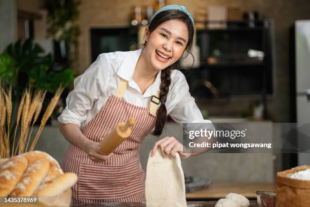 in the bakery, the female chefs  are kneading the dough to prepare the ingredients for the bread production in the bakery. - gifted movie stock pictures, royalty-free photos & images