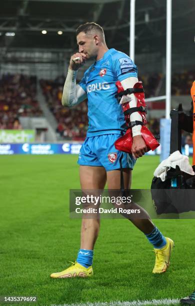 Jonny May of Gloucester walks off the pitch after injuring his left arm during the Gallagher Premiership Rugby match between London Irish and...