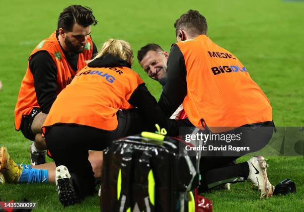 Jonny May of Gloucester grimaces as he receives attention after injuring his left arm during the Gallagher Premiership Rugby match between London...