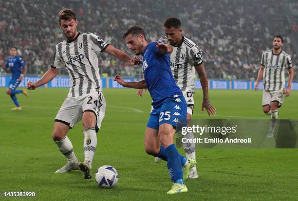 Filippo Bandinelli of Empoli FC is challenged by Daniele Rugani and Danilo Luiz da Silva of Juventus during the Serie A match between Juventus and...