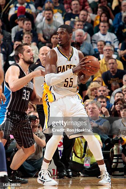 Roy Hibbert of the Indiana Pacers looks to move the ball against Ryan Anderson of the Orlando Magic in Game One of the Eastern Conference...