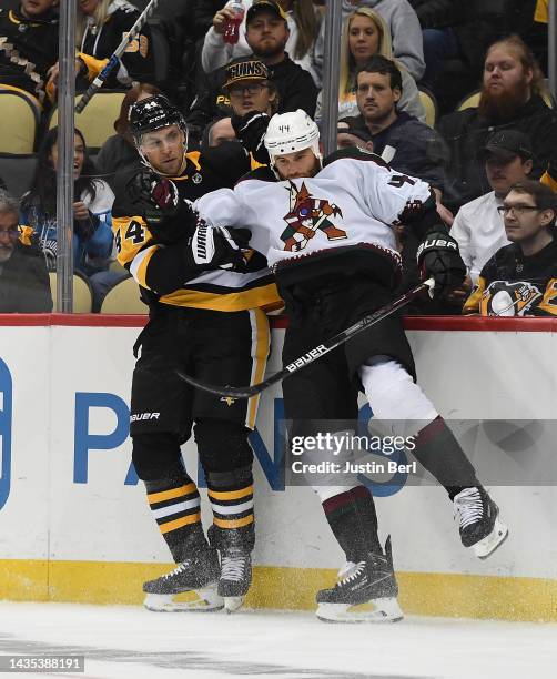 Zack Kassian of the Arizona Coyotes throws a body check on Jan Rutta of the Pittsburgh Penguins in the second period during the game at PPG PAINTS...