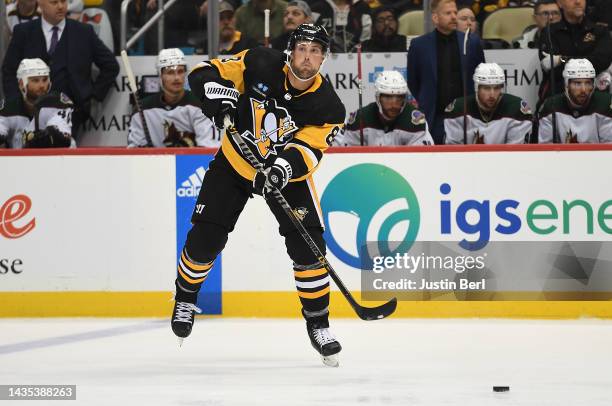 Brian Dumoulin of the Pittsburgh Penguins attempts a pass in the third period during the game against the Arizona Coyotes at PPG PAINTS Arena on...