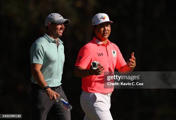 Rory McIlroy of Northern Ireland and Tom Kim of South Korea walk along the 12th hole during the second round of the CJ Cup at Congaree Golf Club on...