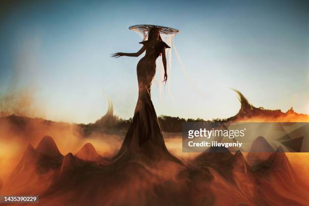 asian gothic woman in hat against backdrop of smoke and blue sky. fashion. witch. halloween look - holy smoke stock pictures, royalty-free photos & images
