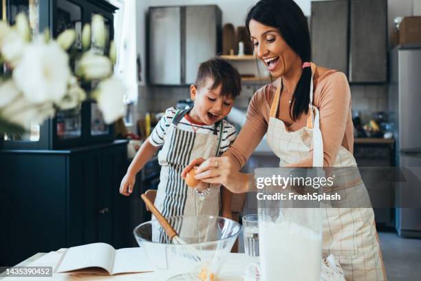 mother and her son making a cake - cooking small kitchen stock pictures, royalty-free photos & images