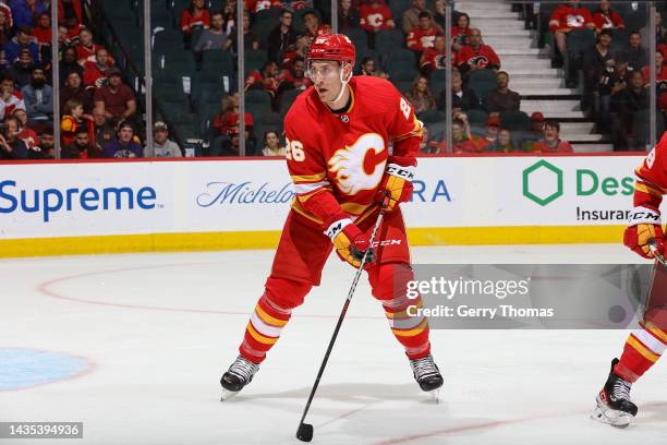 Michael Stone of the Calgary Flames defends against the Buffalo Sabres at Scotiabank Saddledome on October 20, 2022 in Calgary, Alberta, Canada.