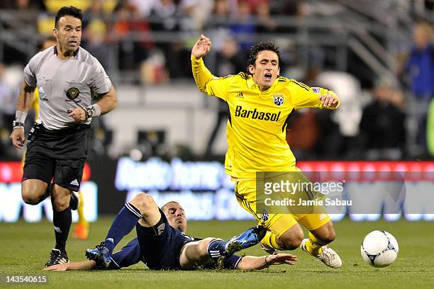 Jordan Harvey of the Vancouver Whitecaps takes down Milovan Mirosevic of the Columbus Crew with a tackle in the second half on April 28, 2012 at Crew...