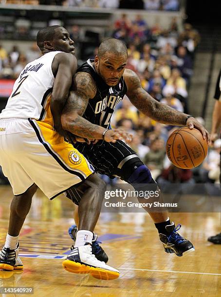 Jameer Nelson of the Orlando Magic drives around the defense of Darren Collison of the Indiana Pacers in Game One of the Eastern Conference...