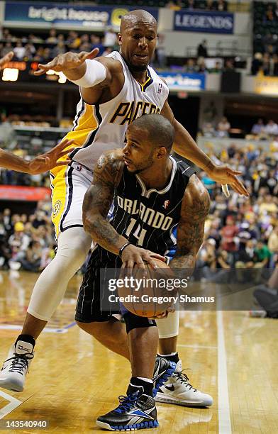 Jameer Nelson of the Orlando Magic tries to pass around the defense of David West of the Indiana Pacers in Game One of the Eastern Conference...
