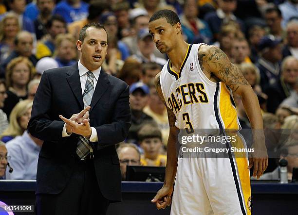 Head coach Frank Vogel talks with George Hill of the Indiana Pacers while playing the Orlando Magic in Game One of the Eastern Conference...