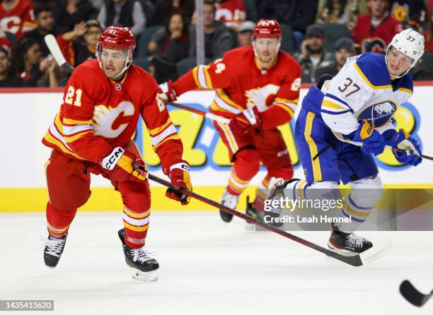 Calgary Flames Kevin Rooney battles against Buffalo Sabres Casey Mittelstadt at Scotiabank Saddledome on October 20, 2022 in Calgary, Alberta Canada.